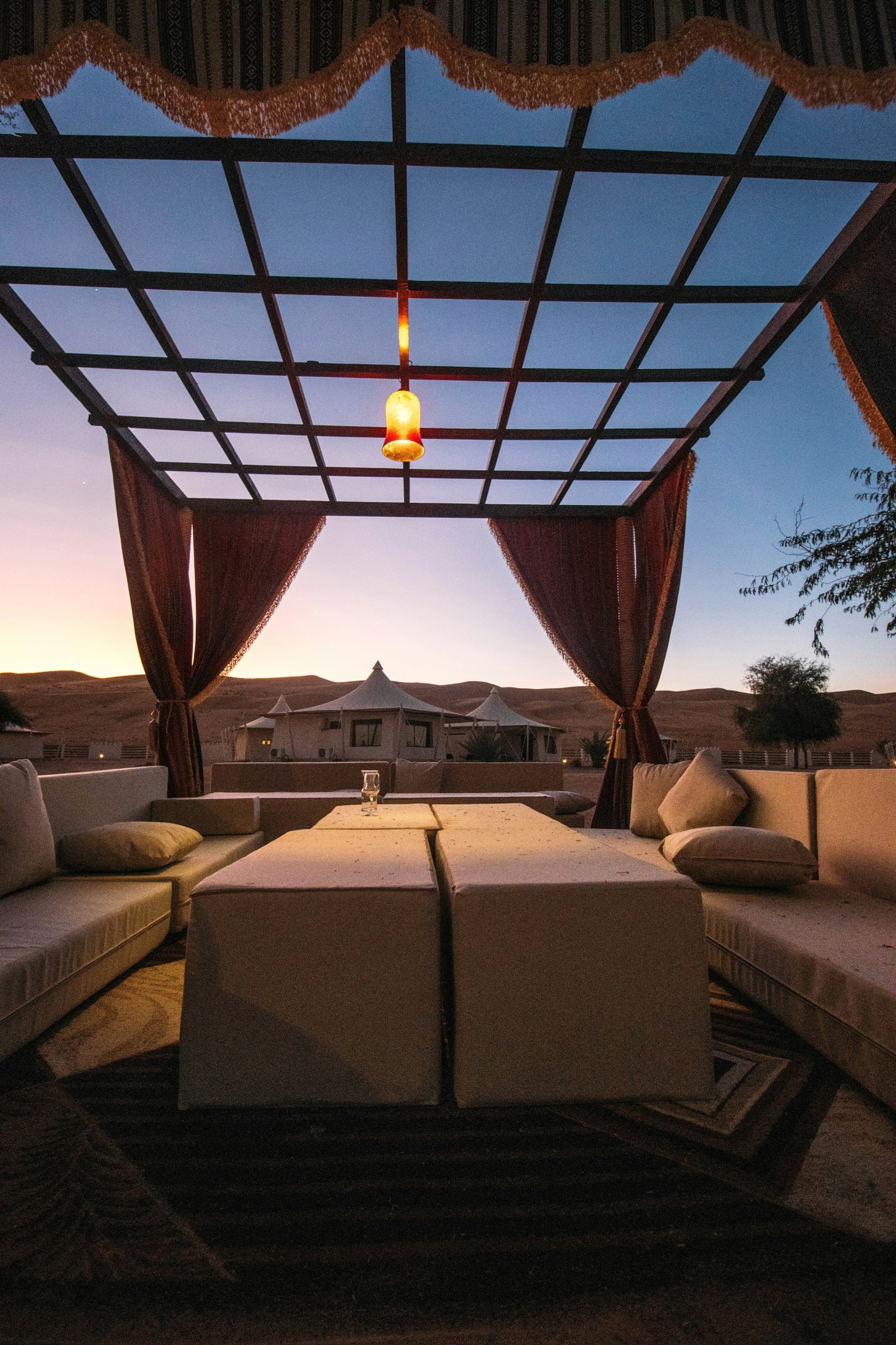 An open beach cabana with a daybed facing the sea